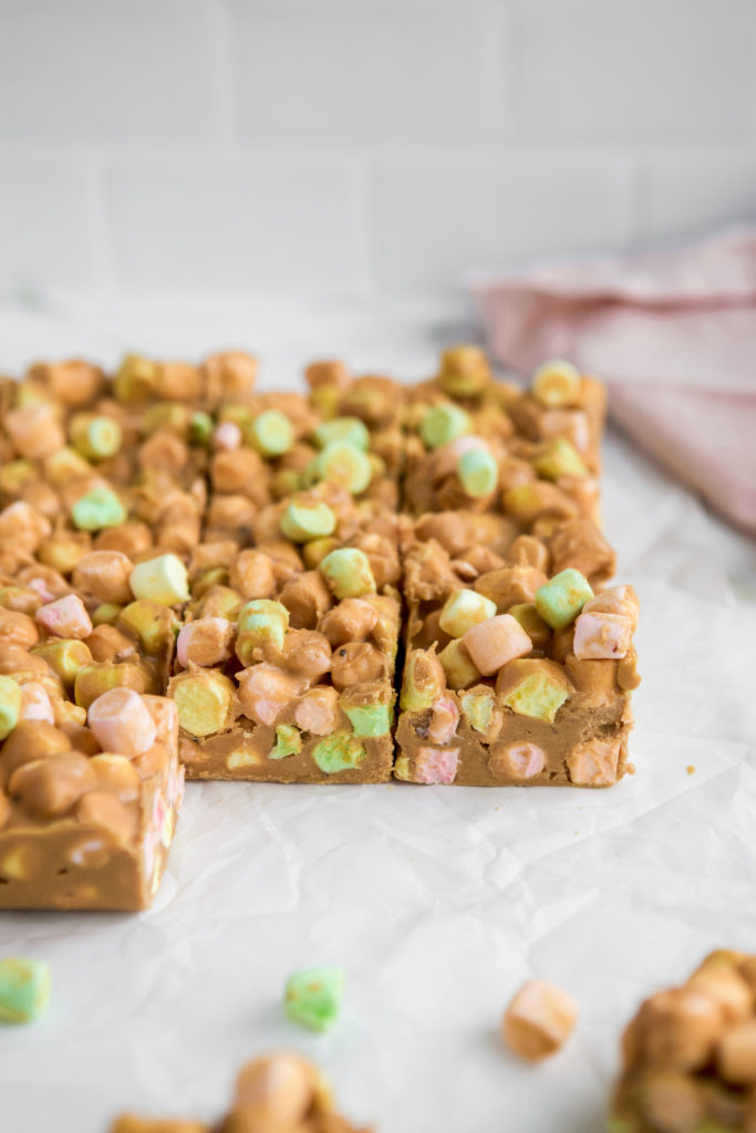 Side view of an easy dessert recipe for christmas on parchment paper with colourful marshmallows.
