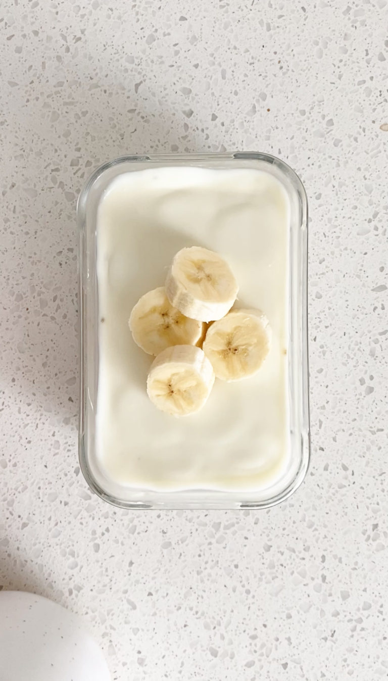 top view of banana cream pie overnight oats with sliced bananas in a glass dish