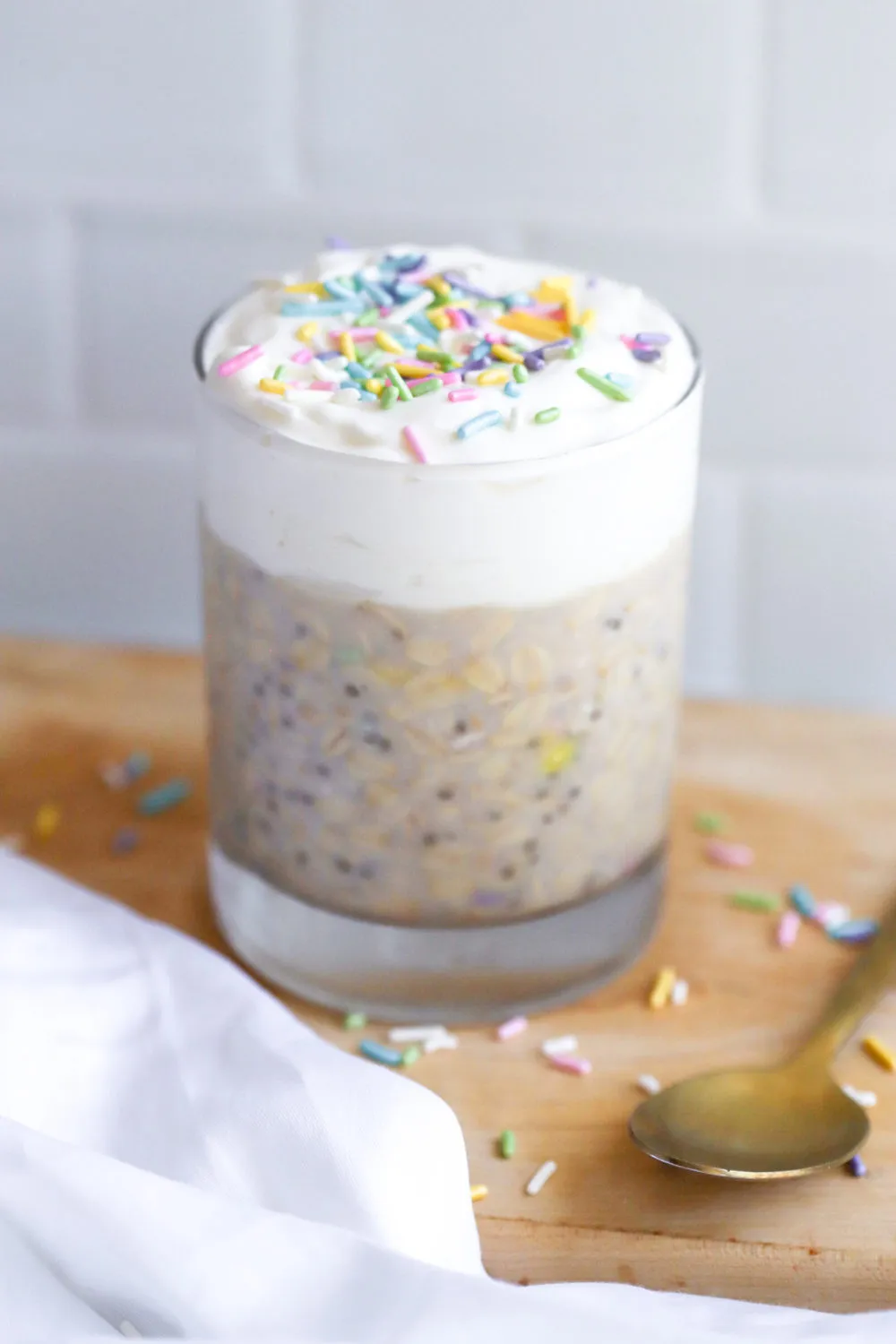 high protein birthday cake overnight oats with sprinkles in a glass cup