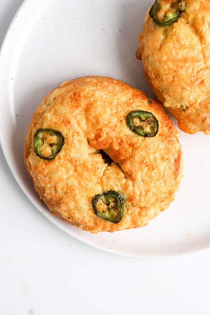 close up shot of top down view of jalapeno bagels with sharp cheddar cheese topping