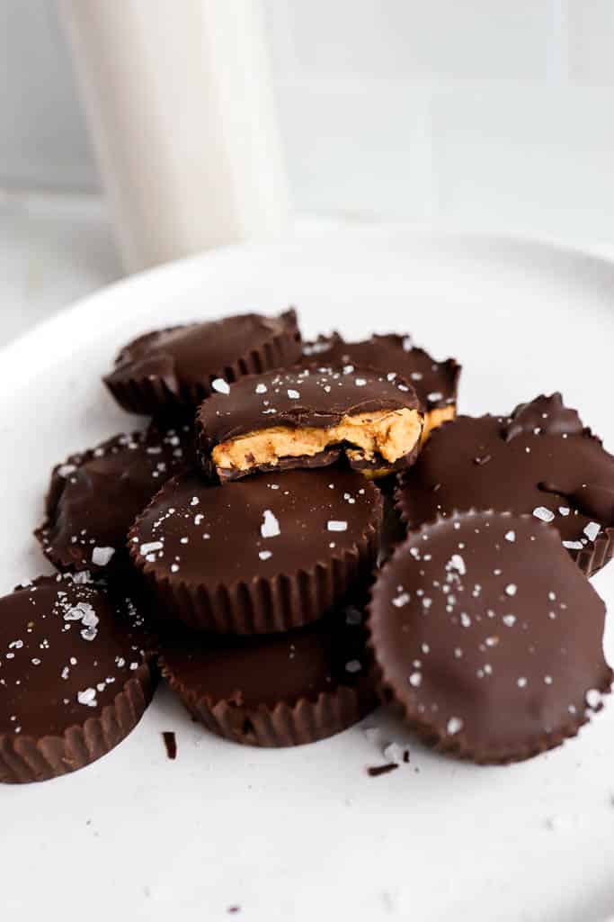 protein peanut butter cups recipe stacked on top of each other on white plate