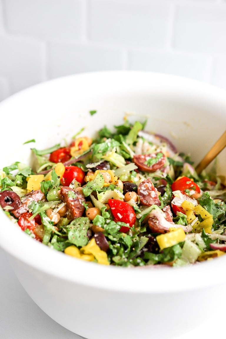 side angle of romaine lettuce and kalamata olives in an italian salad