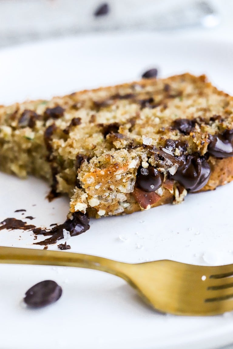 close up shot of banana bread recipe made with overripe bananas on a plate with a gold fork