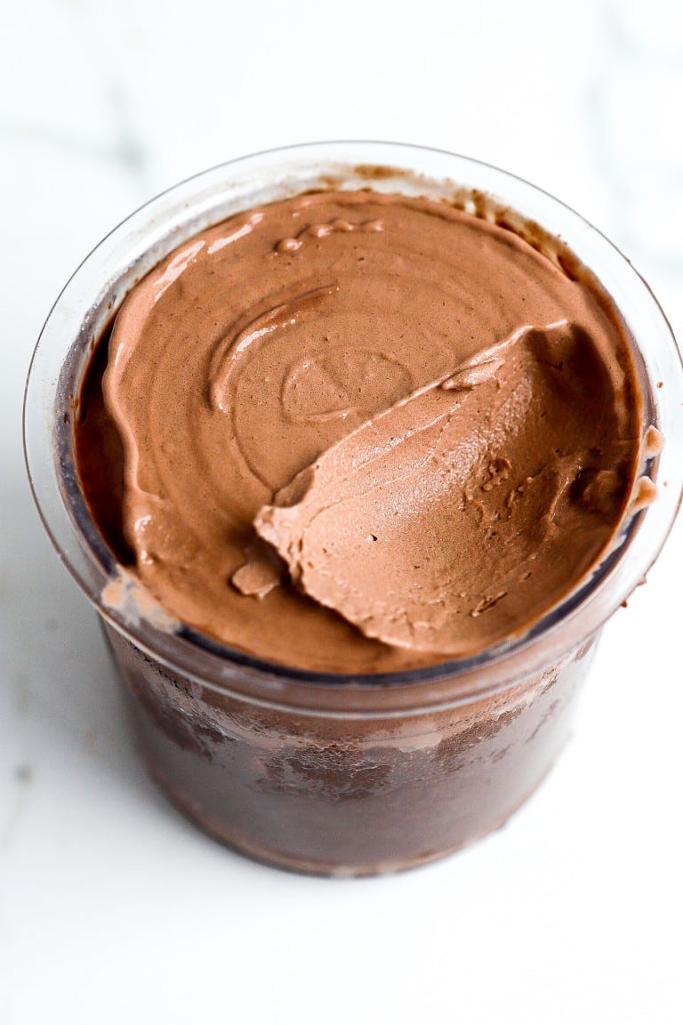 top down view of chocolate protein ice cream in a glass container