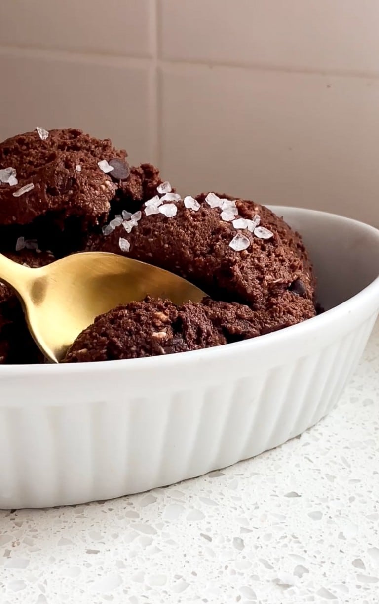 chocolate cottage cheese cookie dough in a white bowl with a gold spoon