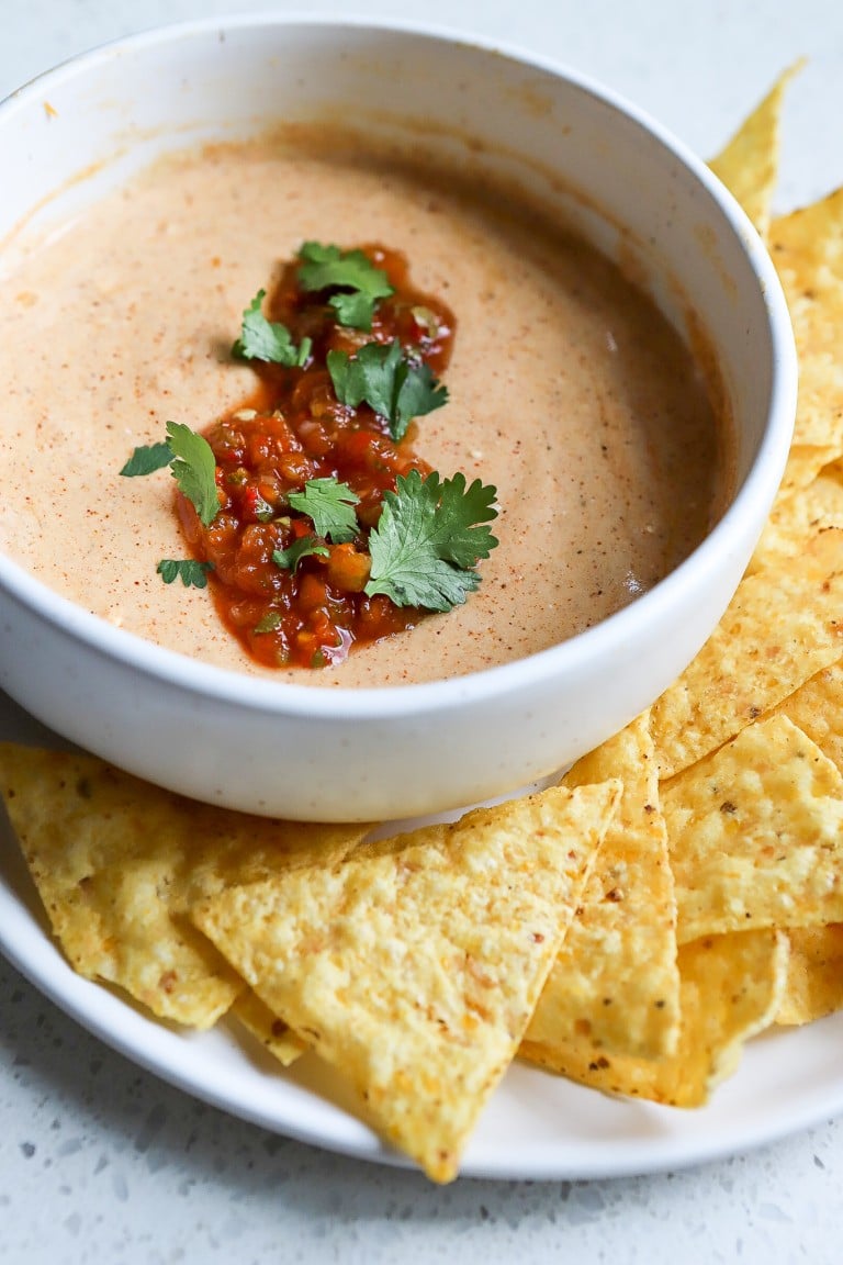 cottage cheese dip recipe in a white bowl with pico de gallo in middle of sauce