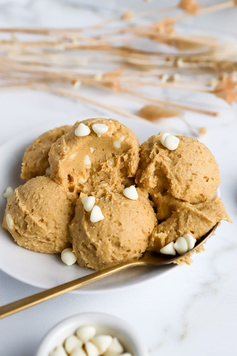 healthy pumpkin cookie dough recipe in white bowl with gold spoon