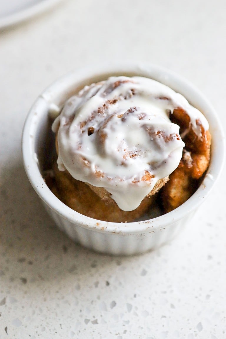 side angle of single serving cinnamon roll recipe with cream cheese icing