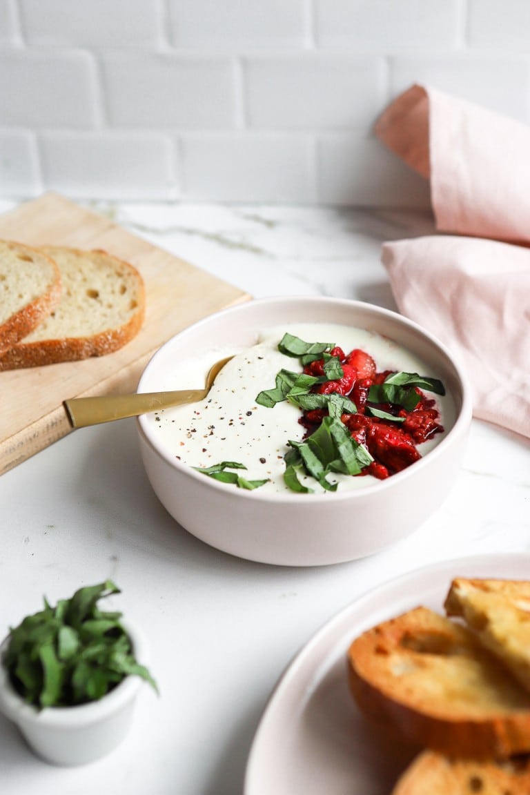 side angle of bowl of strawberry balsamic whipped feta with french bread on the side
