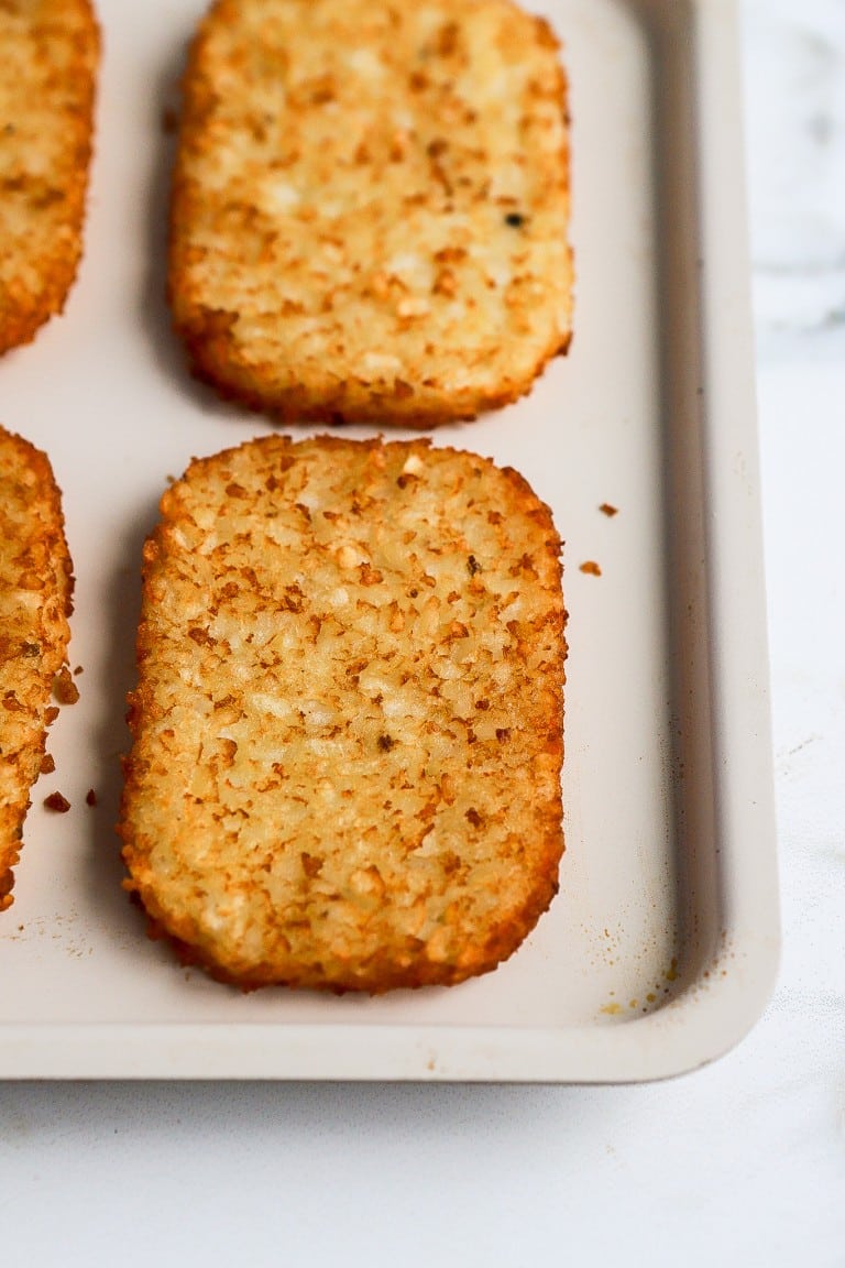 top down view of hashbrowns on air fryer tray