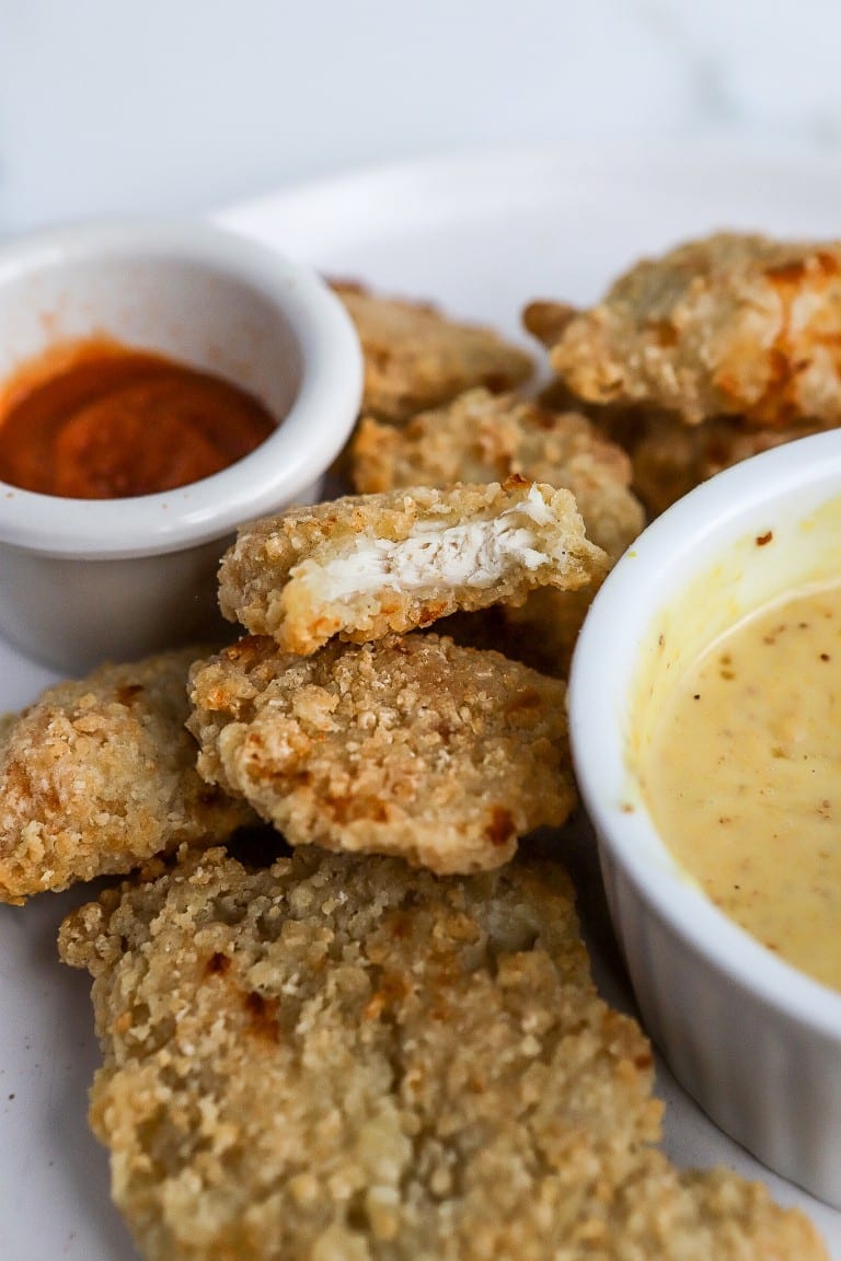 bite shot of an air fryer chicken nugget in a pile