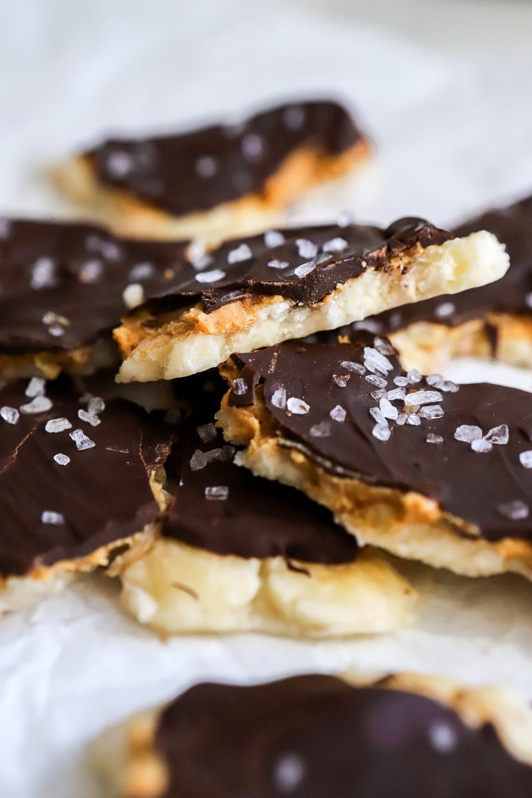 a close up shot of a stack of easy banana bark with a dark chocolate layer on top