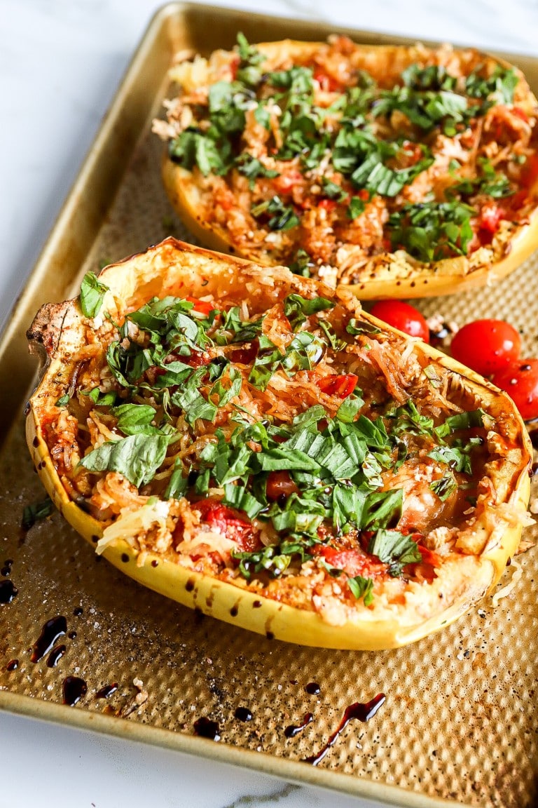 side angle of easy feta pasta recipe with fresh basil on baking sheet