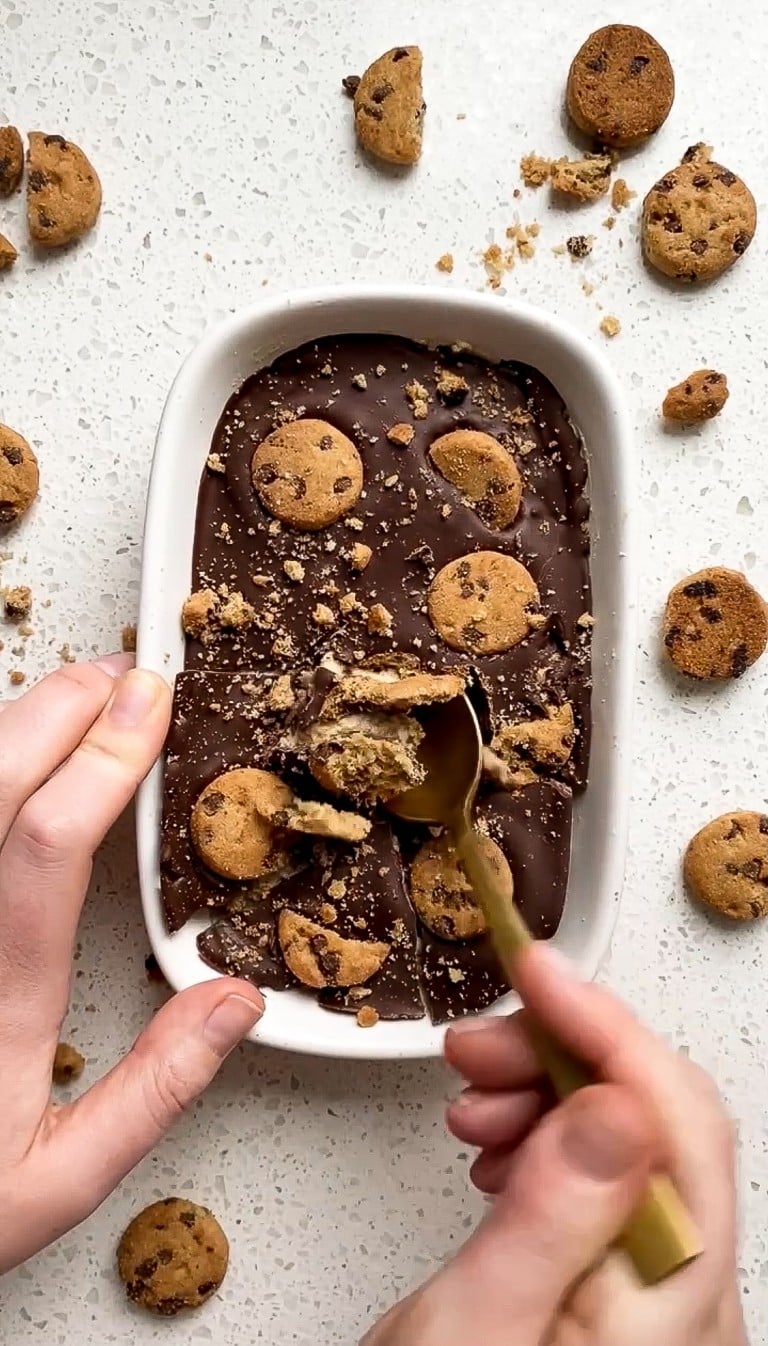 top down view of chocolate chip cookie dough overnight oats with gold spoon diging in