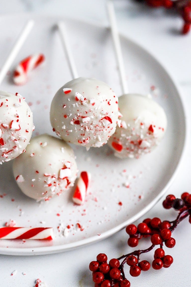 top down view of christmas cake pops with candy canes in foreground