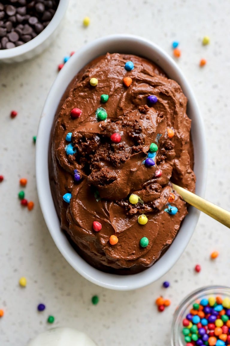 top down view of golf spoon digging into cosmic brownie baked oats in small white ramekin