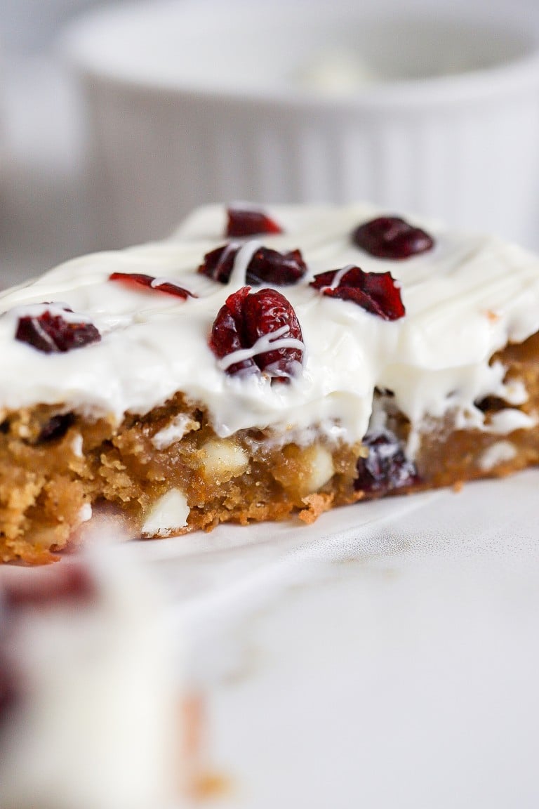 close up view of easy starbucks cranberry bliss bars with a cream cheese frosting