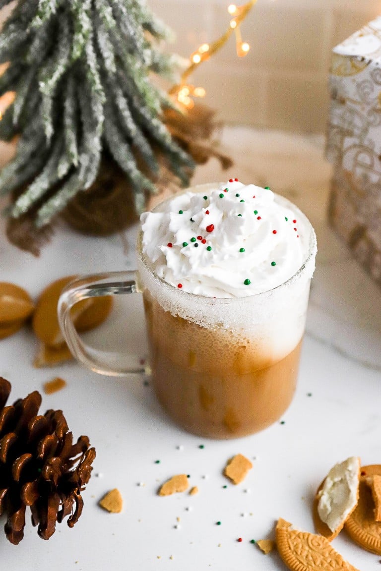 top down view of holiday season starbucks drink made at home in glass mug with green and red sprinkles