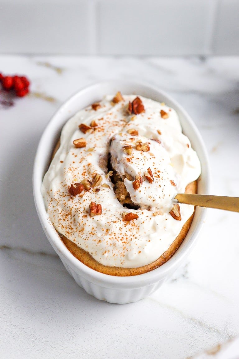 side angle of baked oats recipe in white ramekin with golf spoon