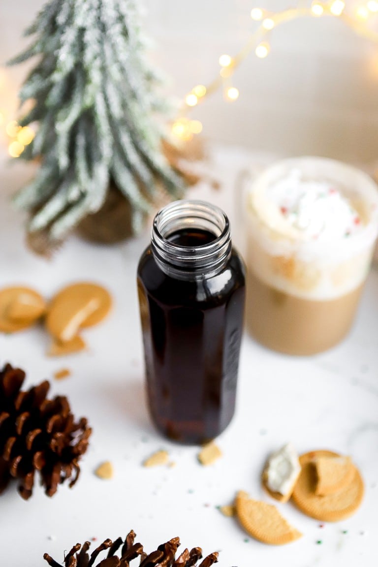 top down view of starbucks sugar cookie syrup in glass jar with christmas decorations on countertop