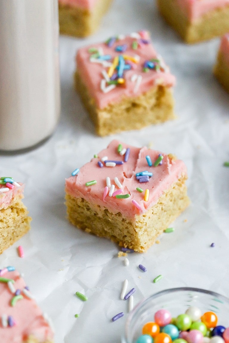 close up of sweet sugar cookie bar on parchment paper