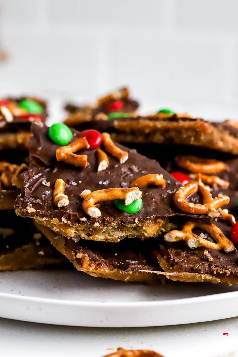 side angle of christmas saltine cracker candy recipe with pretzels on top