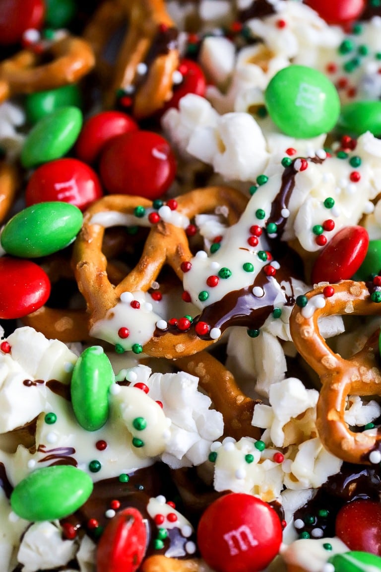 top down view of holiday season popcorn with pretzels and red and green m&m's