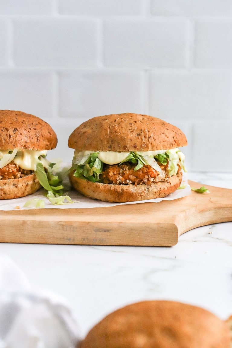 2 healthy copycat mcchicken on a wooden cutting board