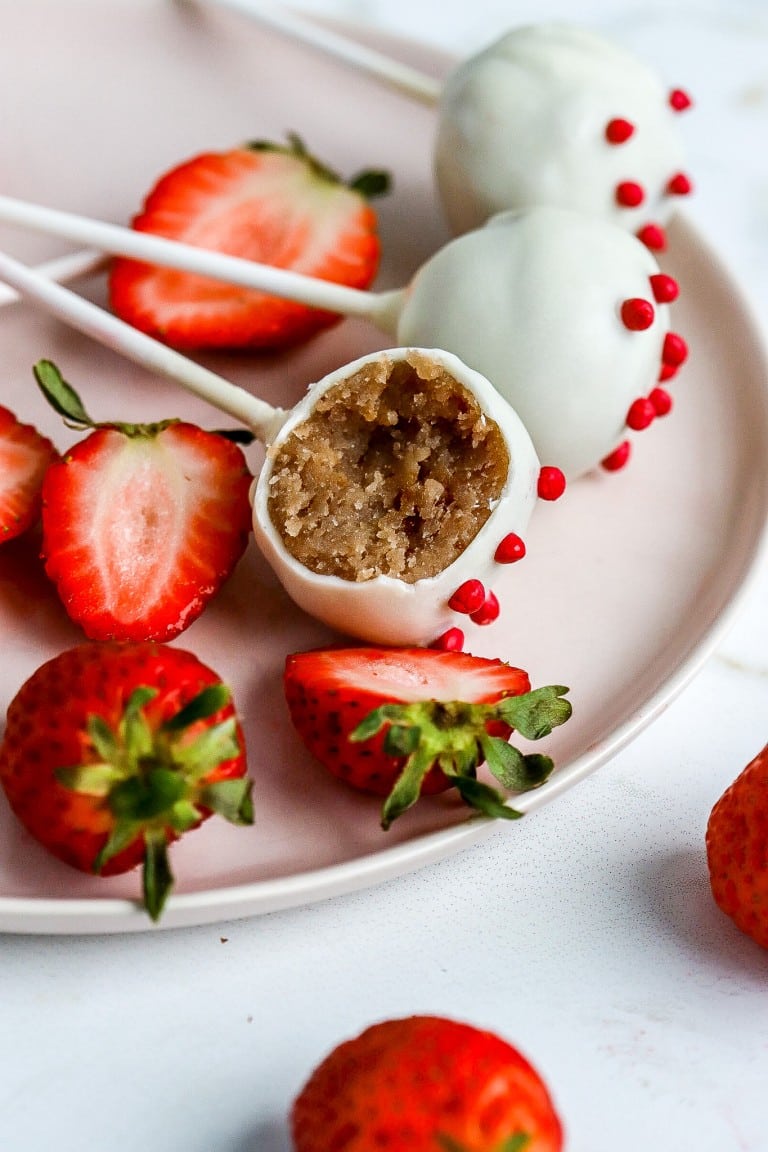 bite shot of Valentine's Day cake pops on blush pink plate