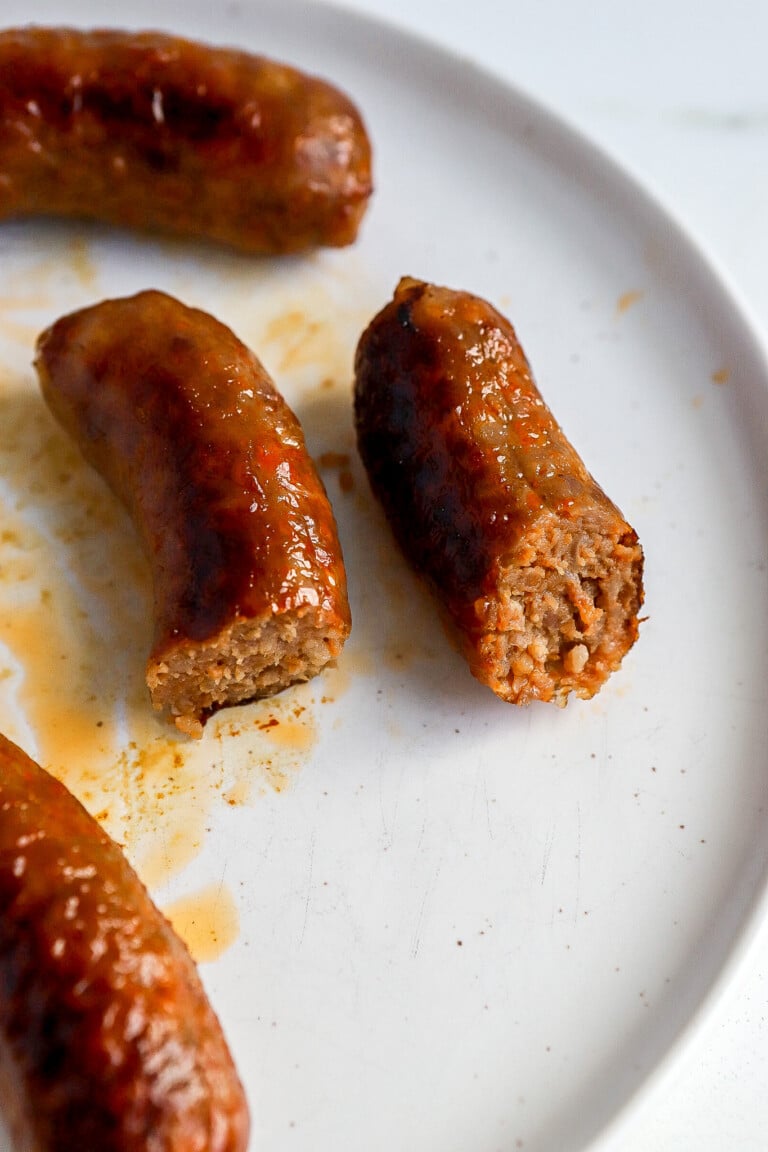 side view of air fryer Italian sausage on white plate