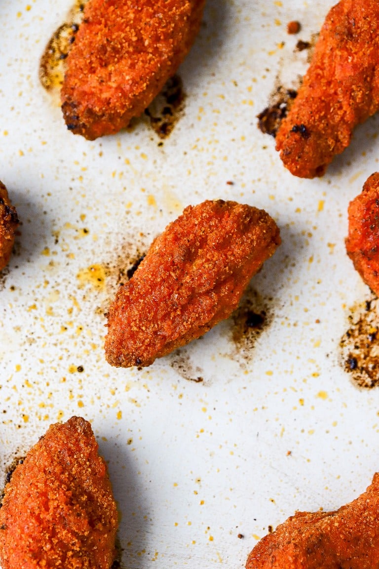 top down view of buffalo sauce cauliflower wings on air fryer tray