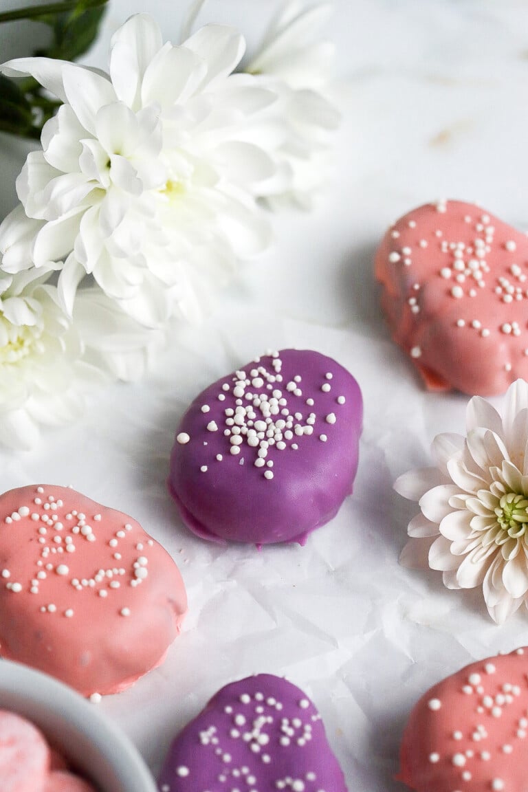 side view of easter Oreo truffles with white flowers in background