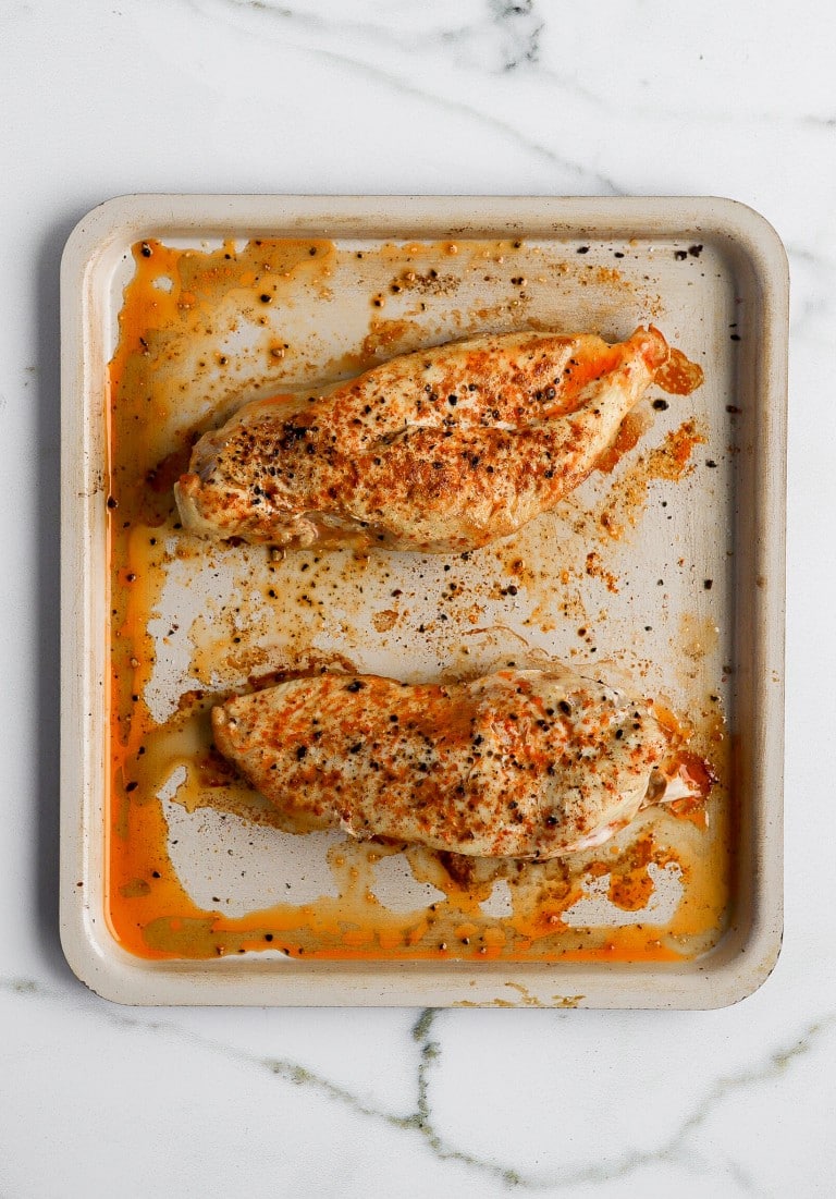 top down view of frozen chicken breasts on air fryer tray