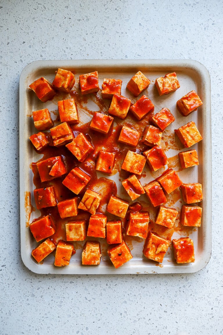 top down view of spicy buffalo tofu on an air fryer tray