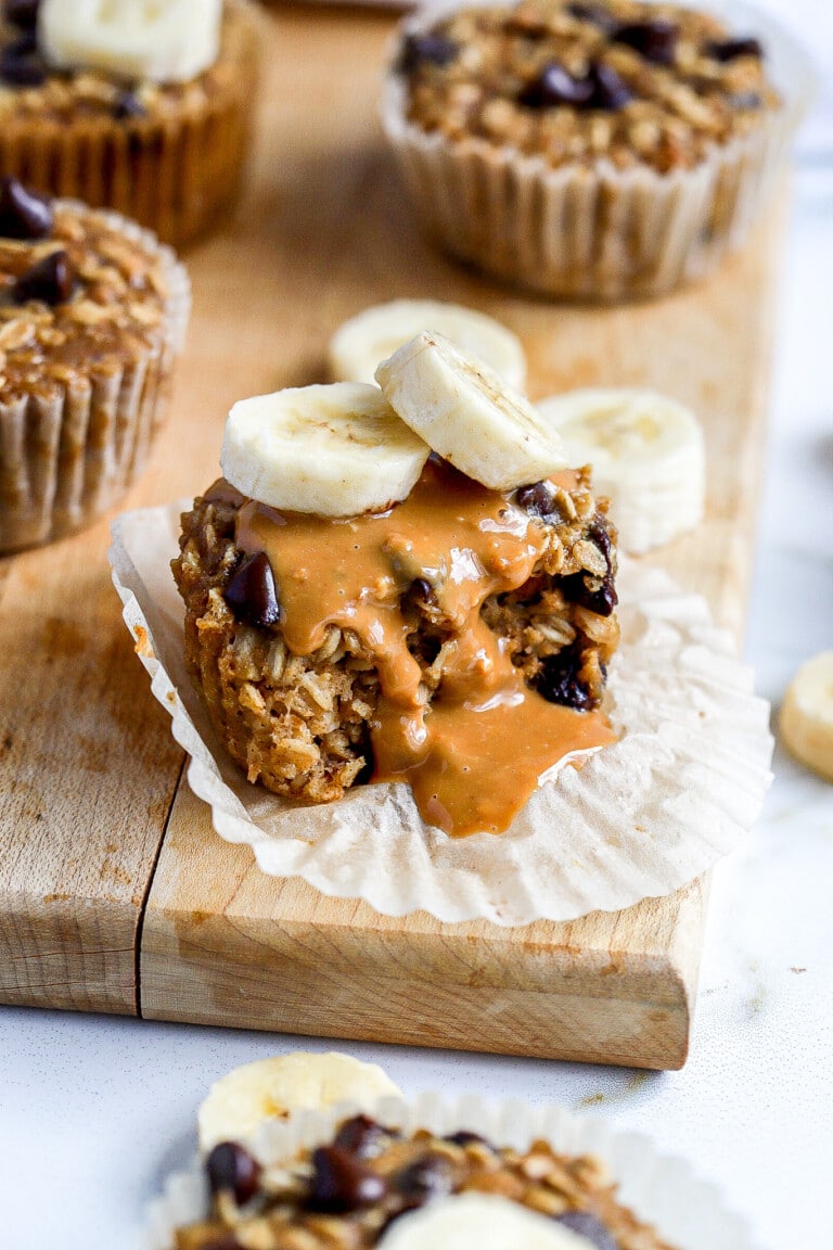 side view of creamy peanut butter oatmeal cups with banana slices on top