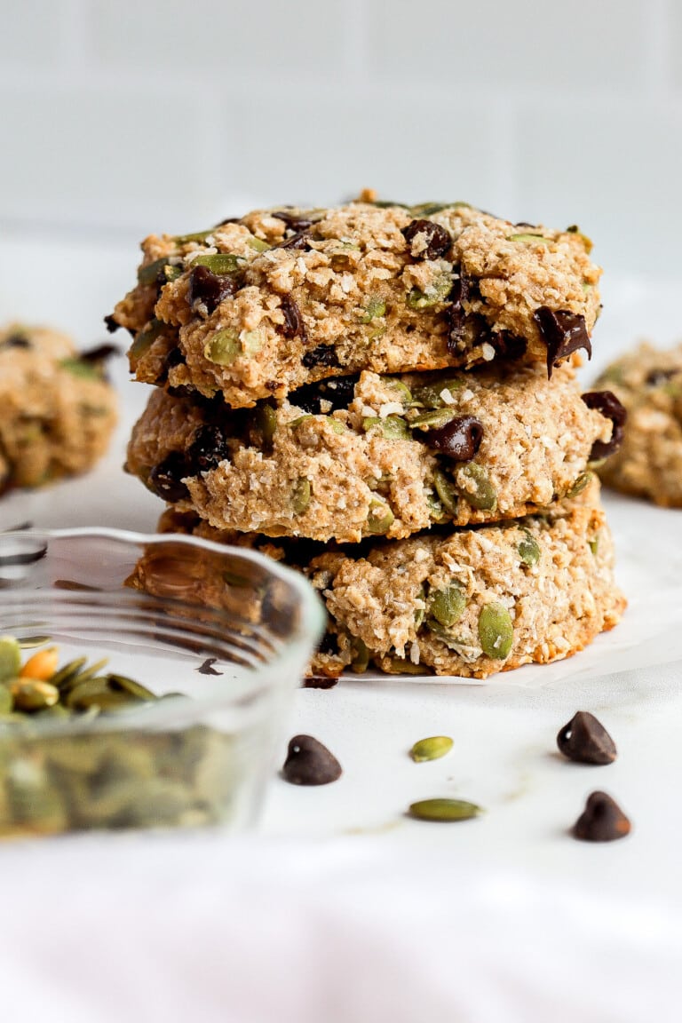 easy breakfast cookies stacked on top of each other with pumpkin seeds and chocolate chips