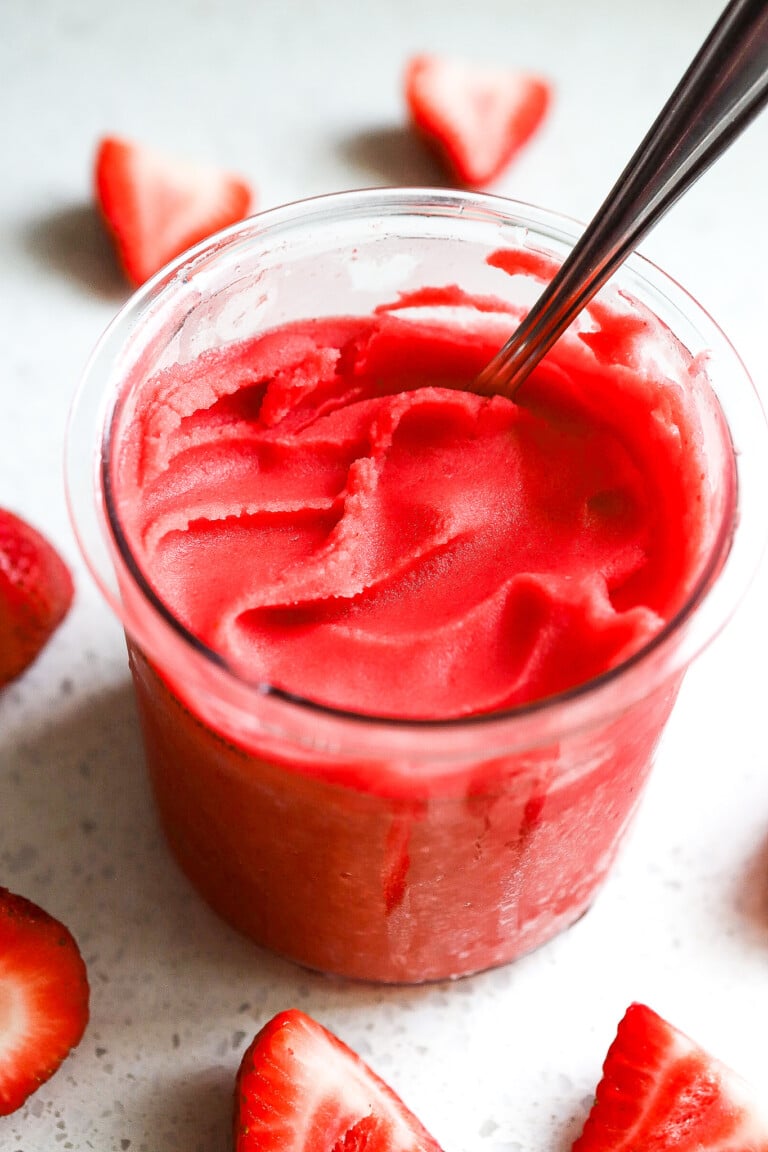 Side angle of a strawberry sorbet in a ninja creami container.