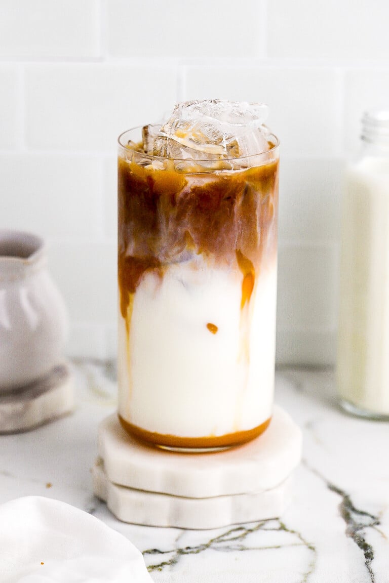 Close up shot of copycat Starbucks iced caramel macchiato in glass with 2% milk.