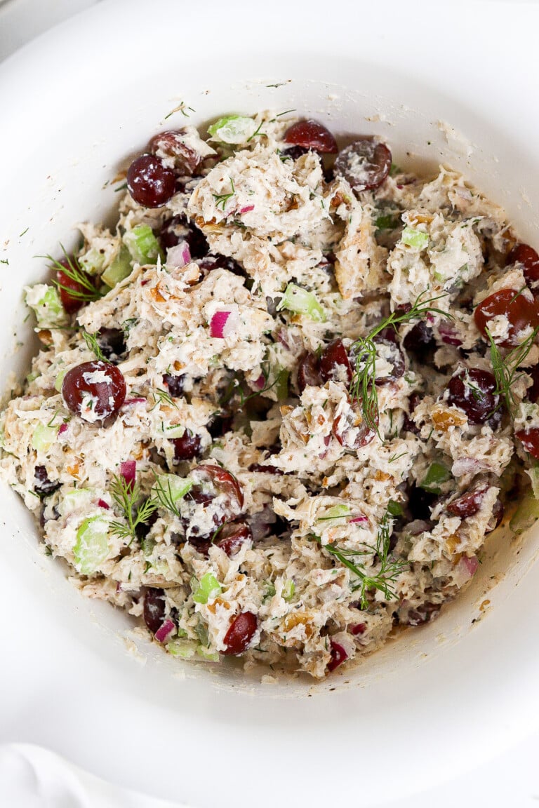 Top down view of easy chicken salad recipe in large white bowl.