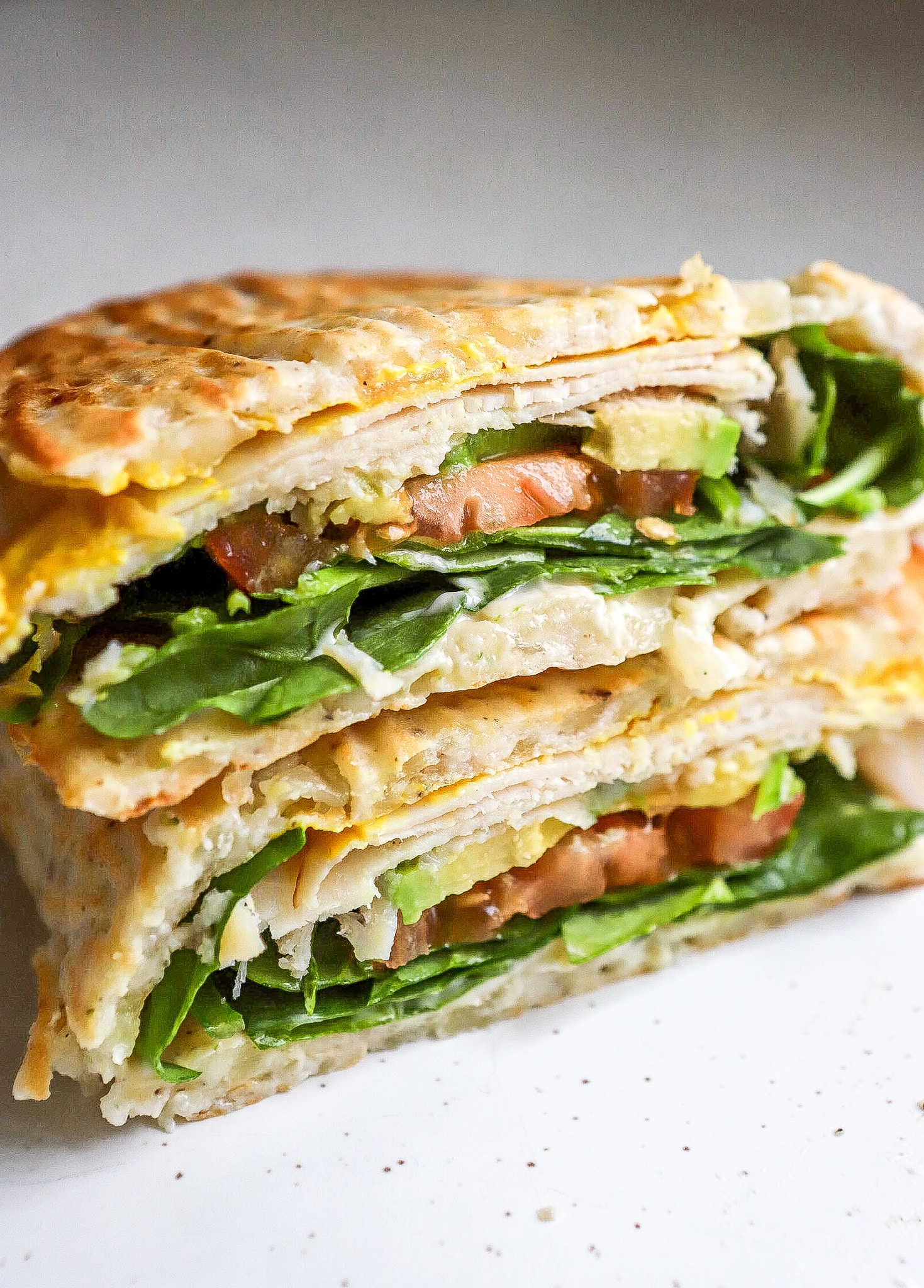 Close up view of easy cottage cheese flatbread made into a sandwich.