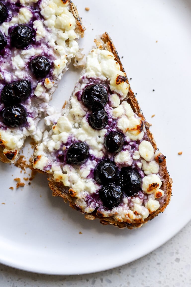 Close up shot of high protein cottage cheese blueberry toast with honey.