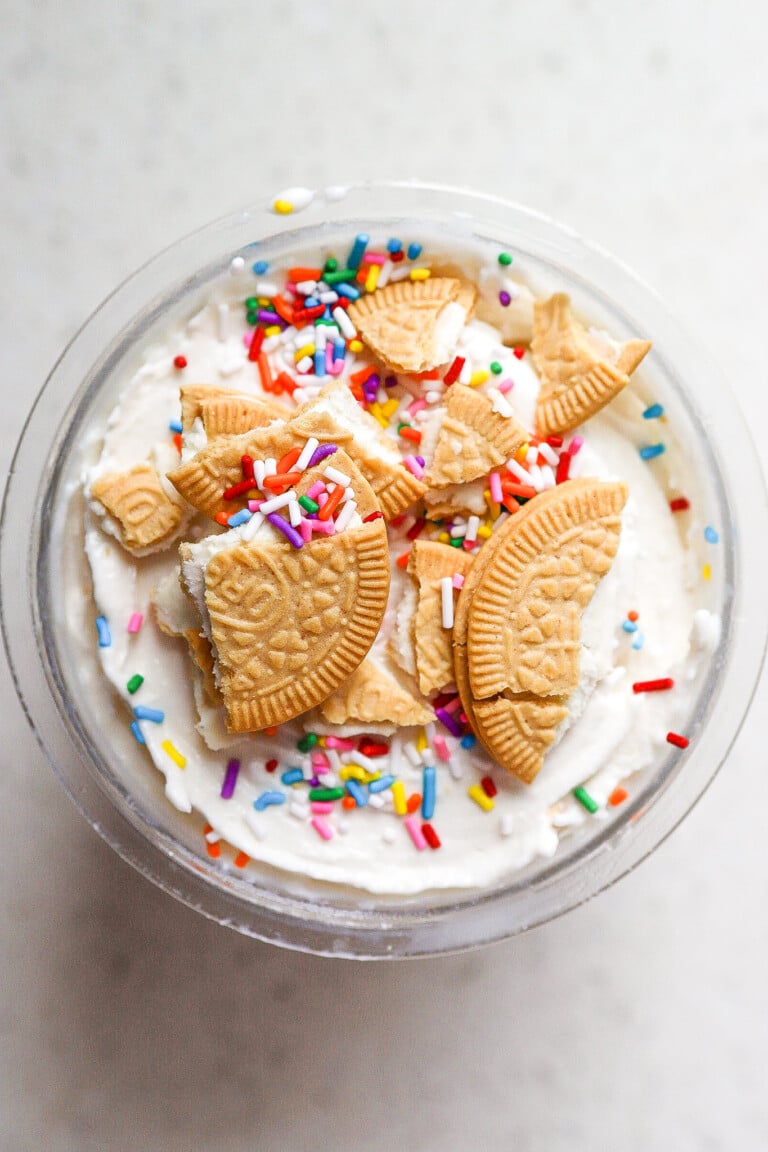 Top down view of ninja creami sugar cookie ice cream with golden Oreos on top.