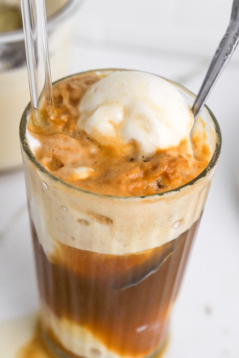Top down view of diet root beer protein float with scoop of ice cream on top in cold glass.