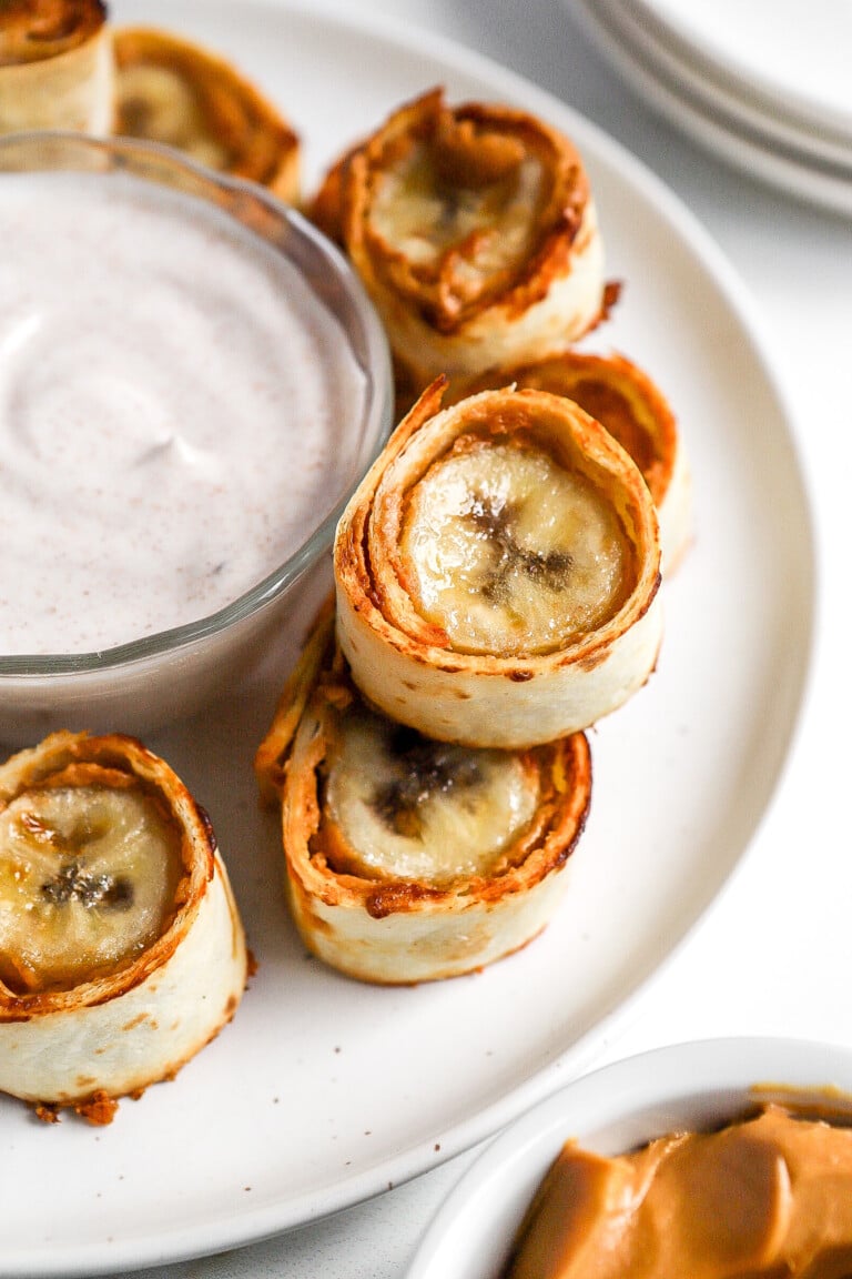 Close up view of a banana rolled up in a tortilla and air fried.