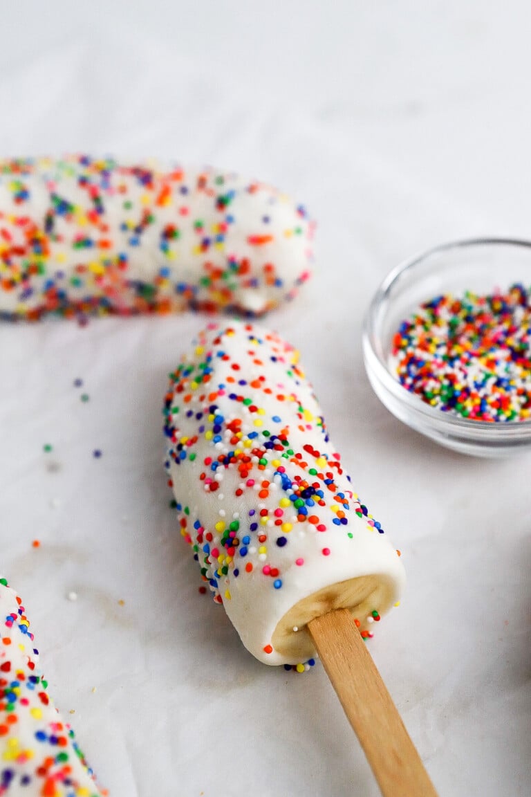 Side view of healthy protein banana pops covered in sprinkles.