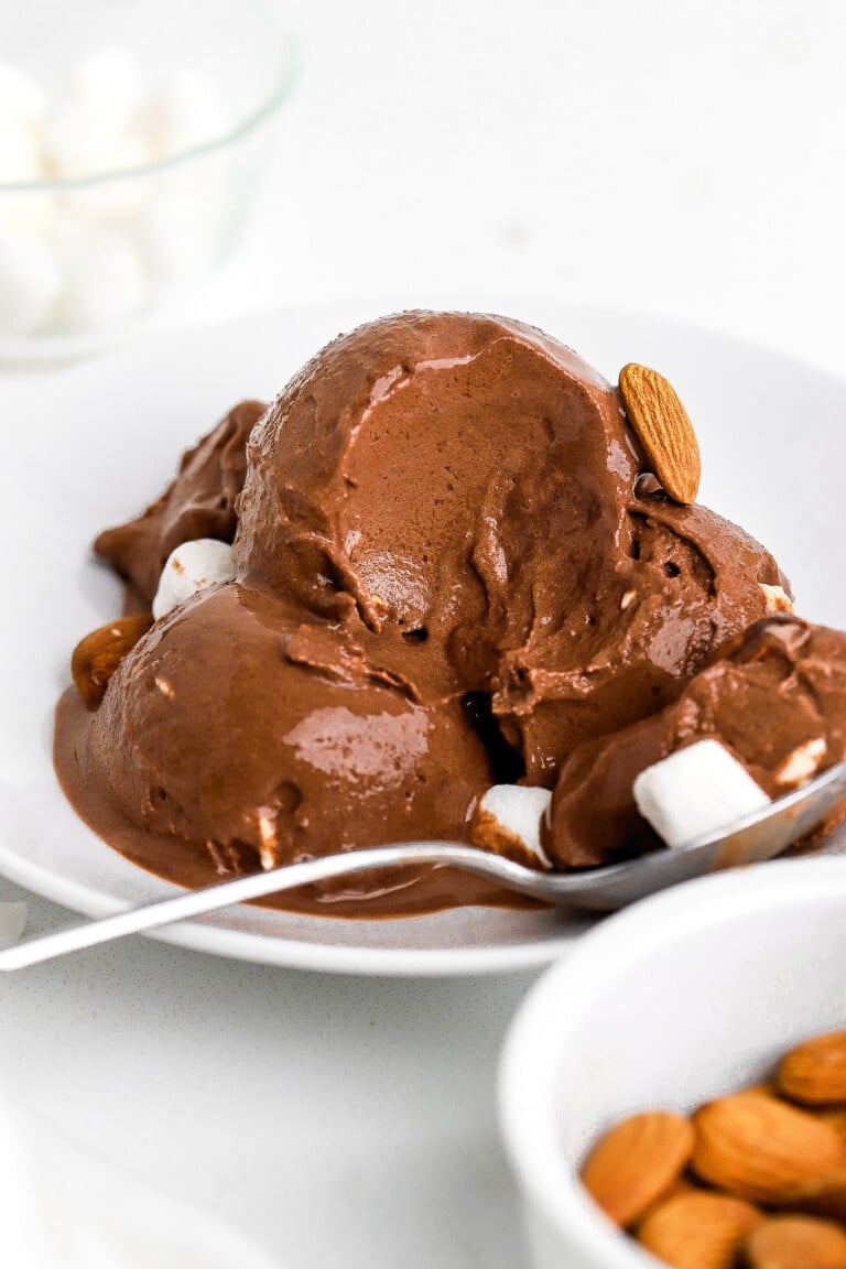 Side view of homemade chocolate ice cream with a scoop taken out.