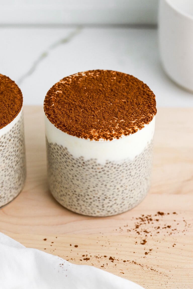 Side view of protein tiramisu chia pudding with a layer of greek yogurt.