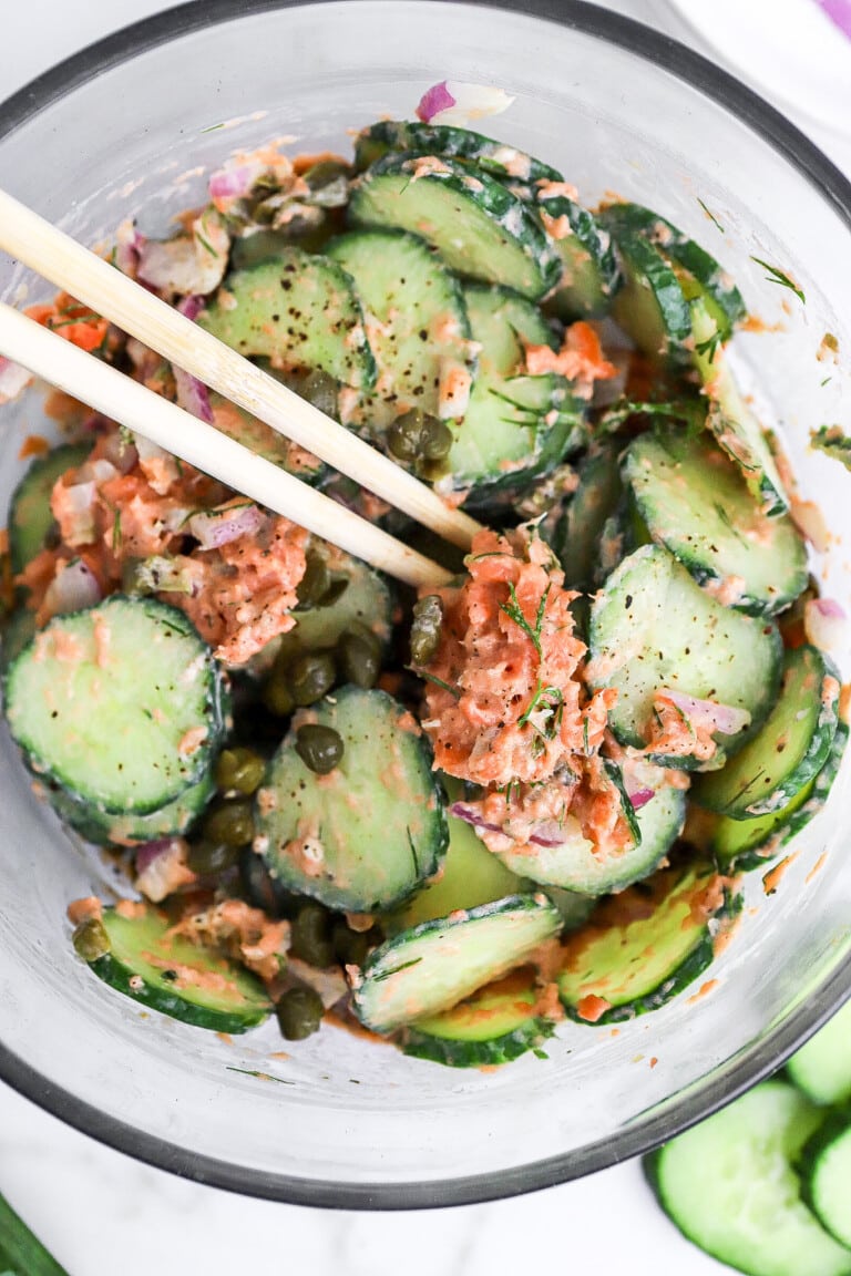 Close up top down view of the viral cucumber salad in a jar with smoked salmon and capers.