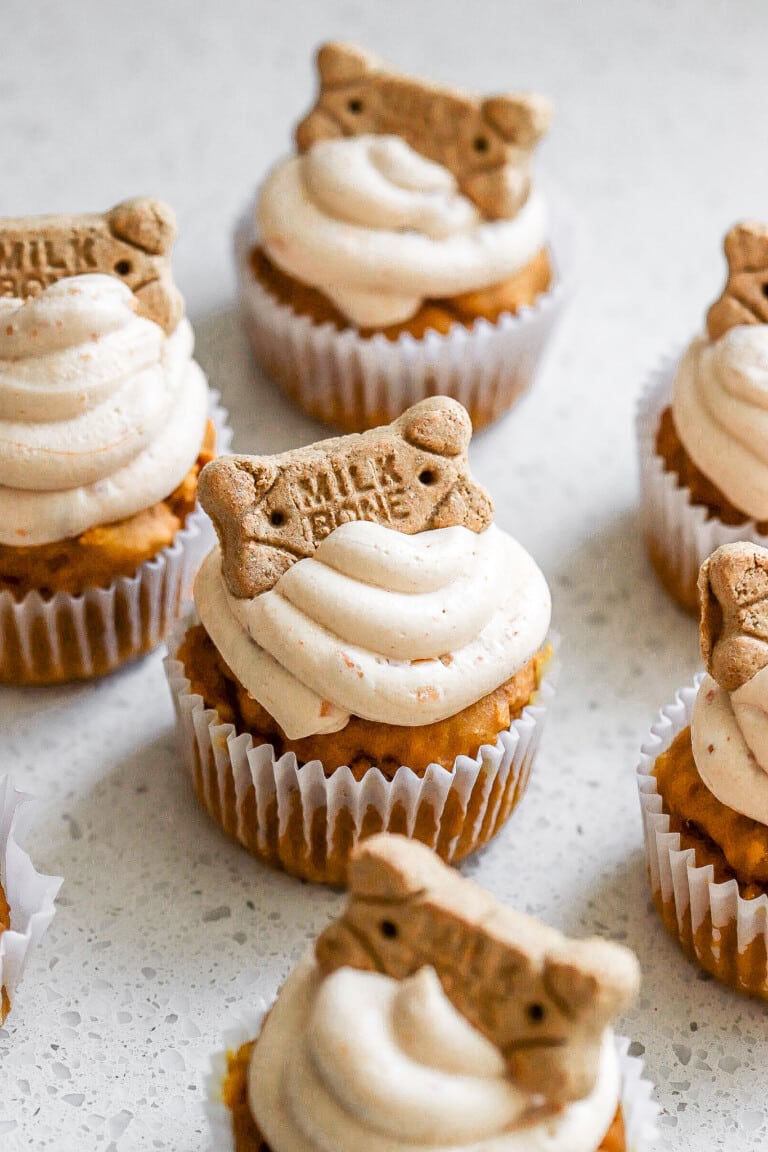 Easy dog cupcakes on white countertop with milk bone on the top.