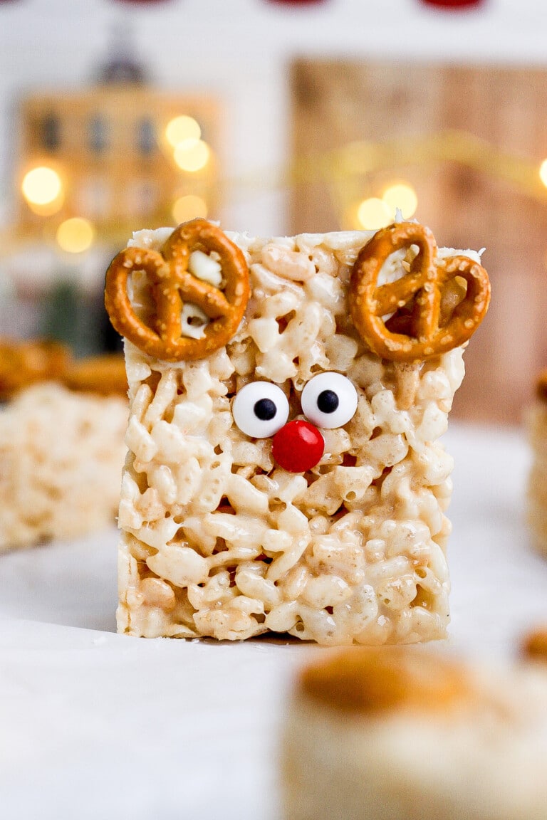 Close up shot of reindeer Rice Krispie treats with pretzel antlers and candy eyes with big red nose.